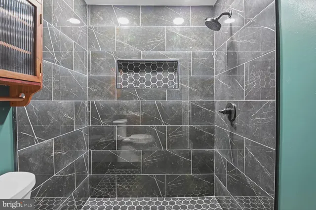 a bathroom with a toilet sink and shower