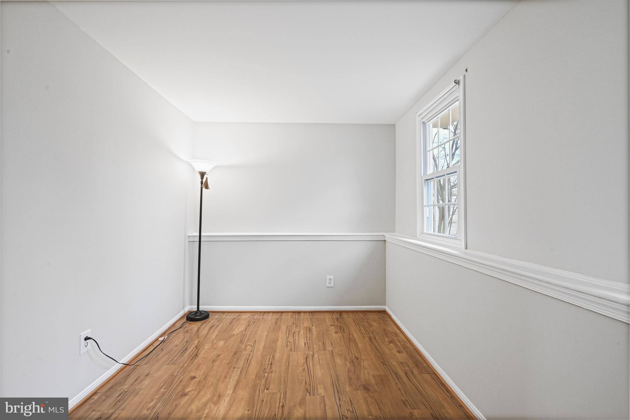 532 Merlins Lane Herndon, VA 20170 - Photo 30 of 42 a view of an empty room with wooden floor and a window