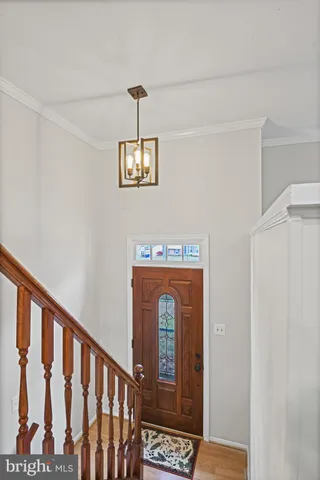 a view of a hallway with wooden floor windows and entryway