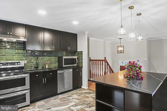 a kitchen with sink cabinets and microwave