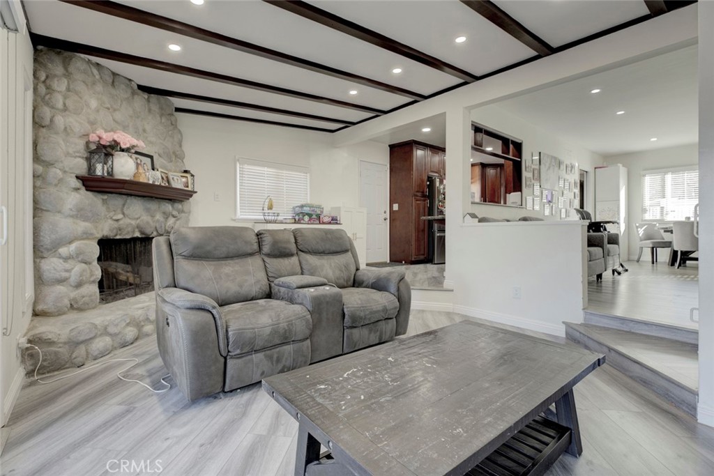 10317 Pinyon Avenue Tujunga, CA 91042 - Photo 16 of 41 a living room with furniture and a fireplace