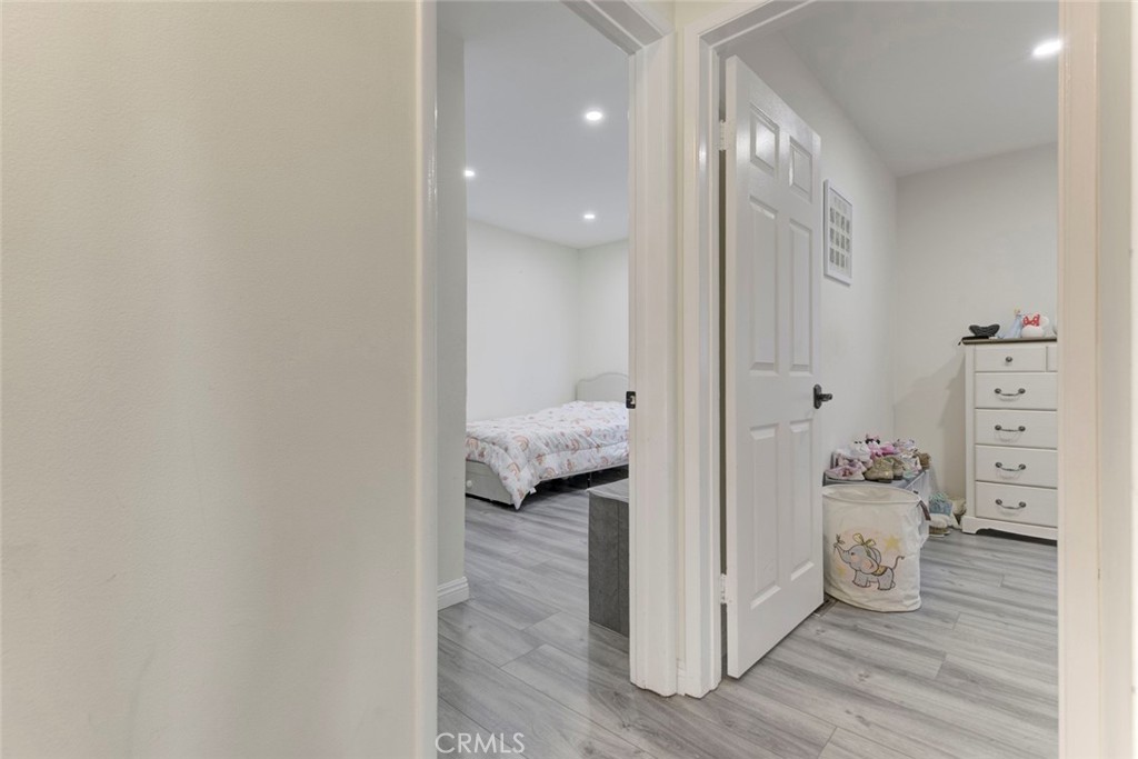 10317 Pinyon Avenue Tujunga, CA 91042 - Photo 19 of 41 a view of a hallway with wooden floor and bedroom