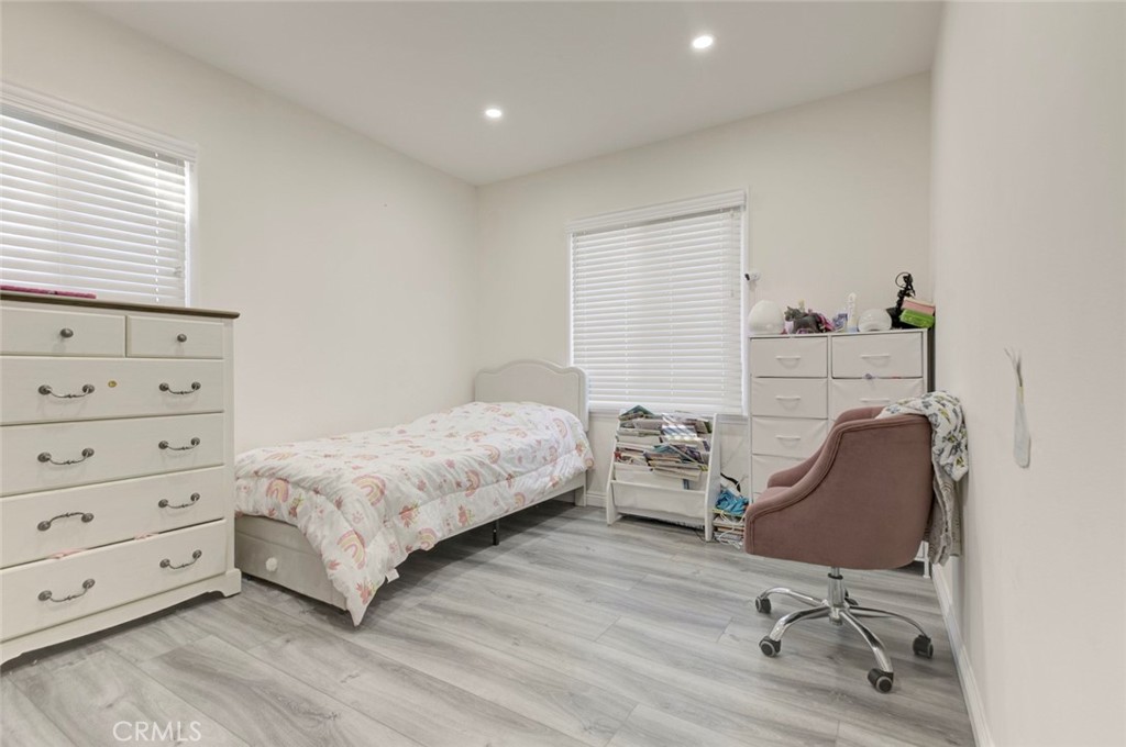 10317 Pinyon Avenue Tujunga, CA 91042 - Photo 22 of 41 a bedroom with a bed and a chair