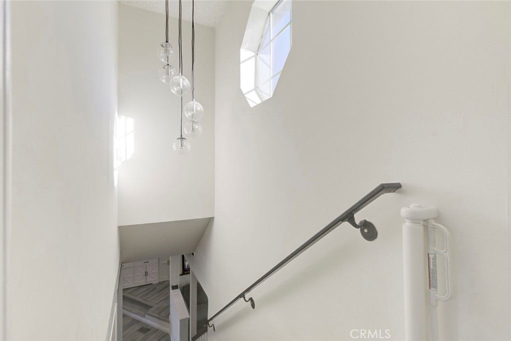 10317 Pinyon Avenue Tujunga, CA 91042 - Photo 24 of 41 a bathroom with a light fixture a mirror and a shower