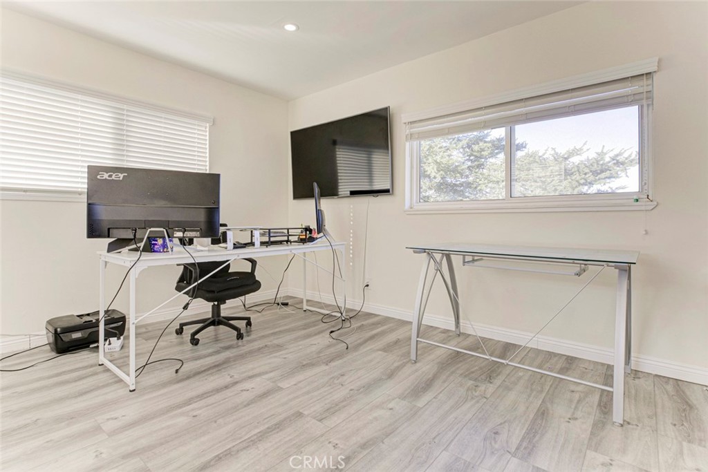 10317 Pinyon Avenue Tujunga, CA 91042 - Photo 25 of 41 a view of a workspace with furniture and a flat screen tv