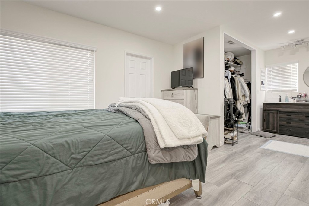 10317 Pinyon Avenue Tujunga, CA 91042 - Photo 38 of 41 a bedroom with a bed and wooden floor