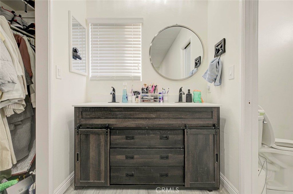 10317 Pinyon Avenue Tujunga, CA 91042 - Photo 40 of 41 a bathroom with a sink and a mirror