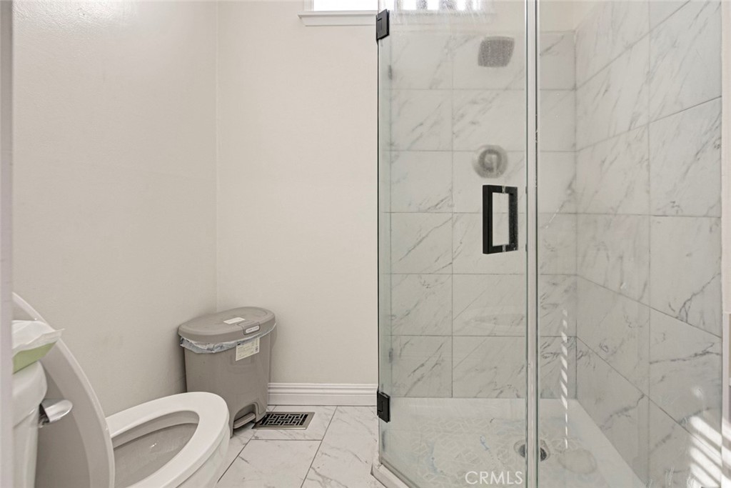 10317 Pinyon Avenue Tujunga, CA 91042 - Photo 41 of 41 a white toilet sitting next to a bath tub