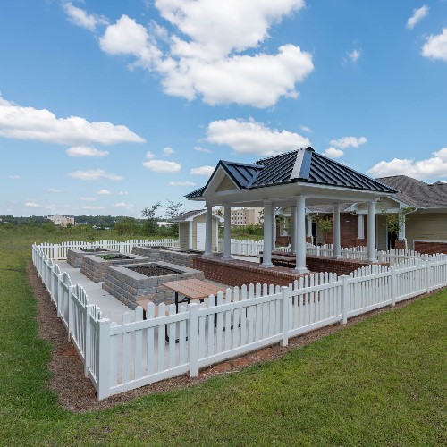 372 East Ash Street Cochran, GA 31014 - Photo 2 of 6 a view of a house with a wooden deck and a garden