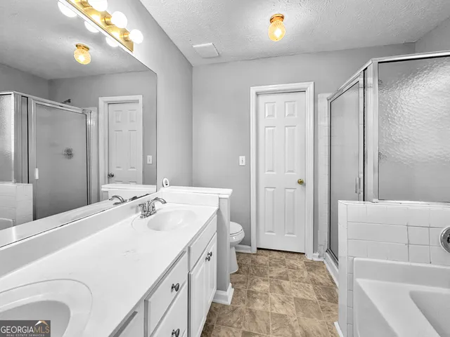 a bathroom with a tub sink and mirror