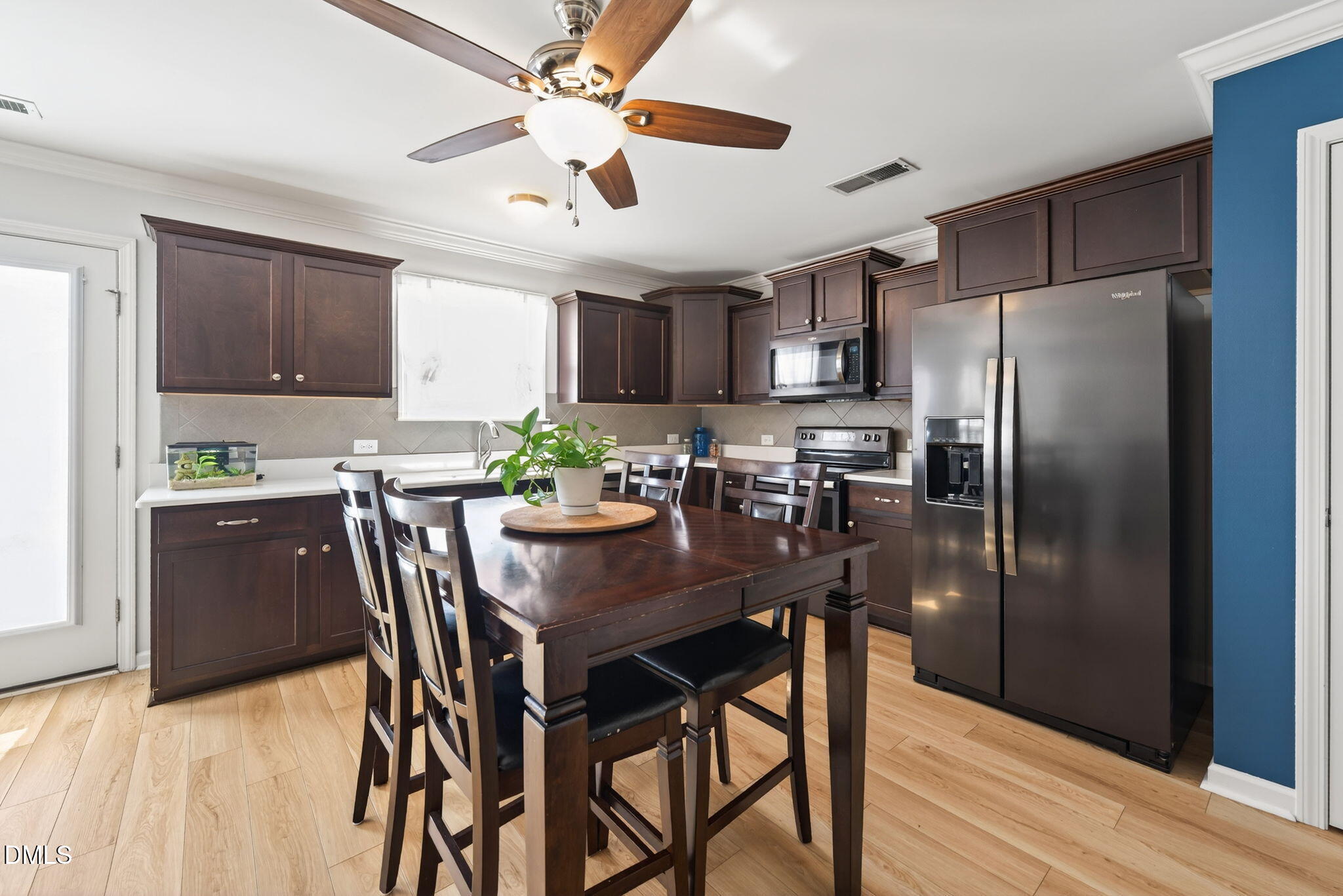 509 Houndstooth Lane Wendell, NC 27591 - Photo 12 of 33 a kitchen with stainless steel appliances granite countertop a dining table chairs refrigerator and cabinets