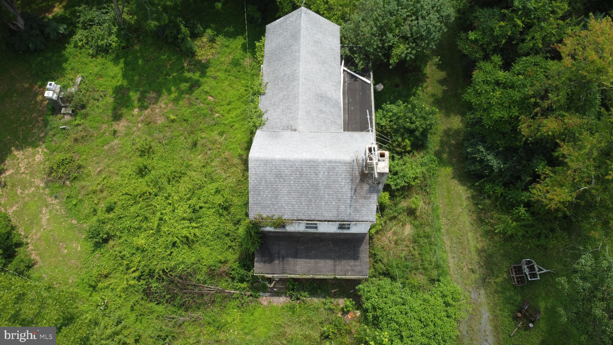an aerial view of a house with a yard and tree s