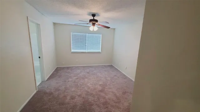 a bathroom with a granite countertop sink a toilet and a bathtub