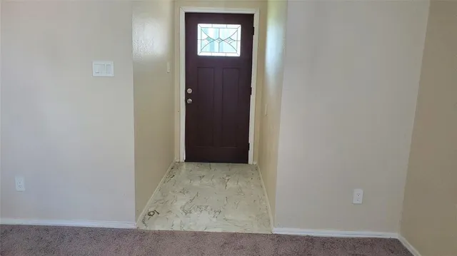 a view of empty room with fireplace
