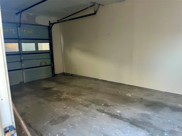 a view of a roof deck with table and chairs under an umbrella with wooden floor