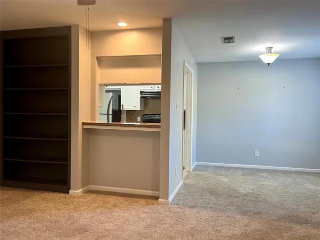 an empty room with closet and a fireplace