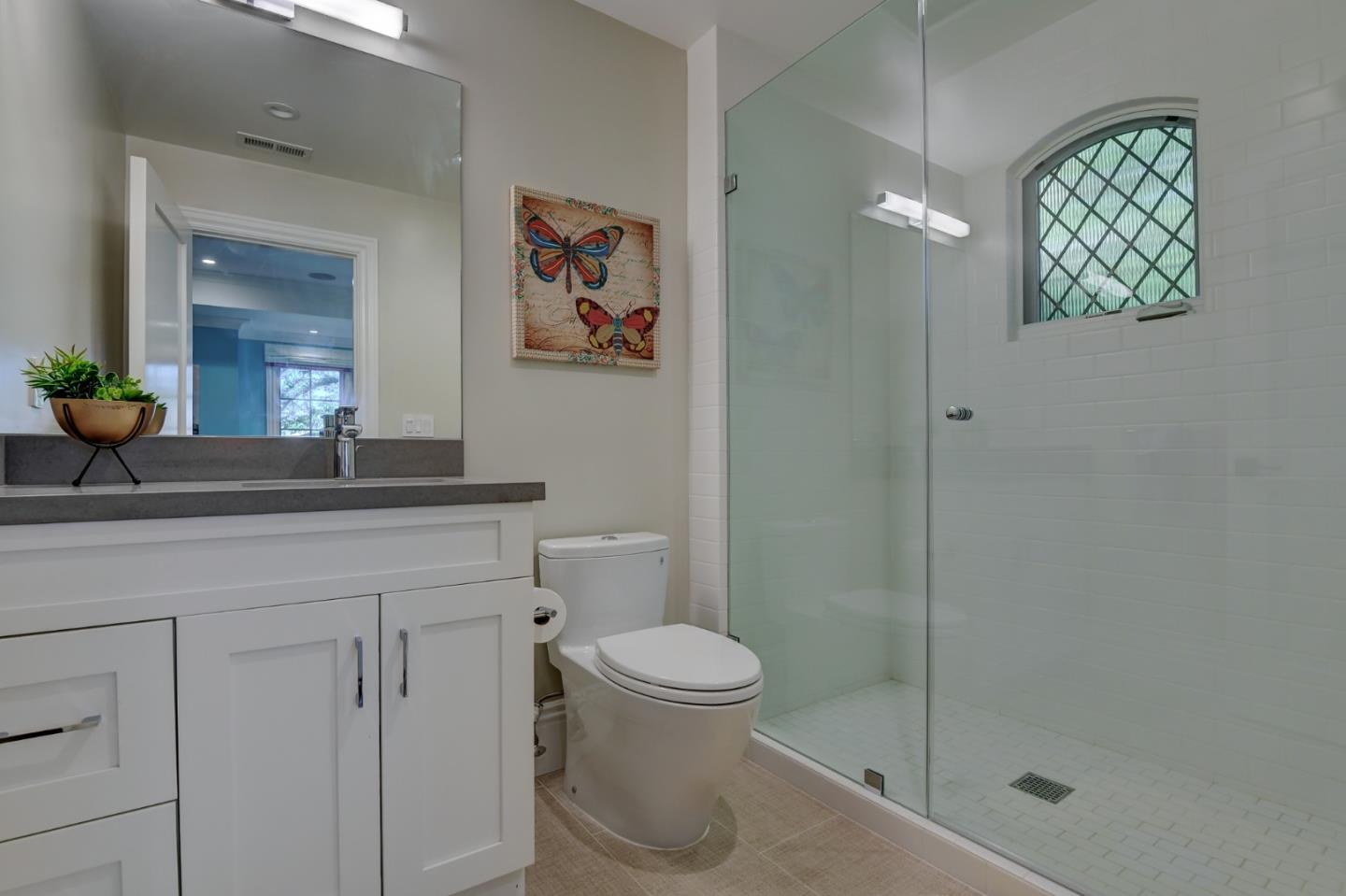 1025 Cabrillo Avenue Burlingame, CA 94010 - Photo 18 of 39 a bathroom with a granite countertop sink a toilet and shower