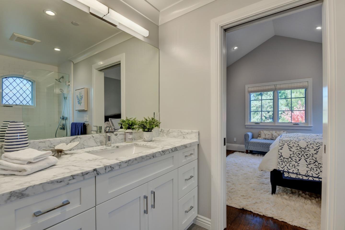 1025 Cabrillo Avenue Burlingame, CA 94010 - Photo 21 of 39 a en suite bathroom with a granite countertop sink and a mirror