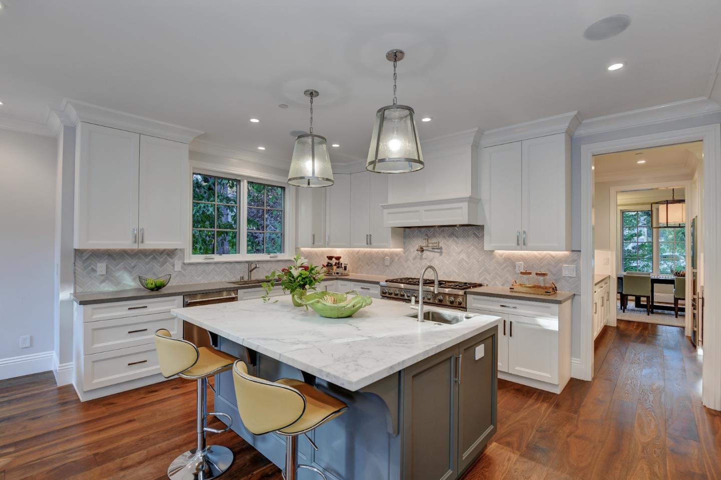 1025 Cabrillo Avenue Burlingame, CA 94010 - Photo 6 of 39 a kitchen with a stove a sink a kitchen island with wooden floor and cabinets