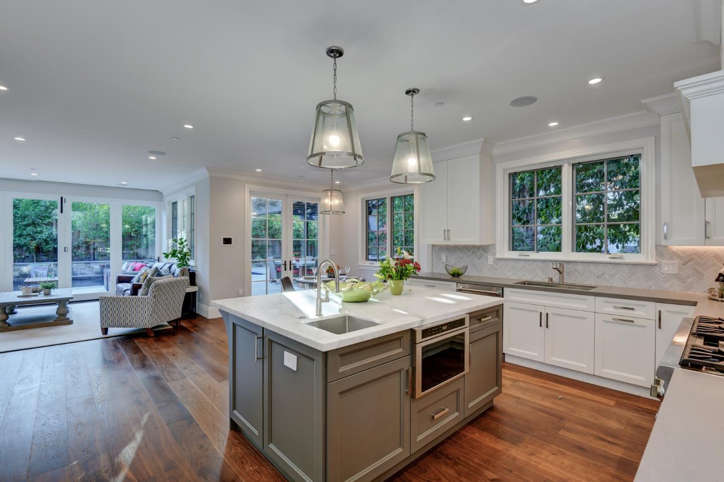 1025 Cabrillo Avenue Burlingame, CA 94010 - Photo 7 of 39 a kitchen with a sink stove and wooden floor
