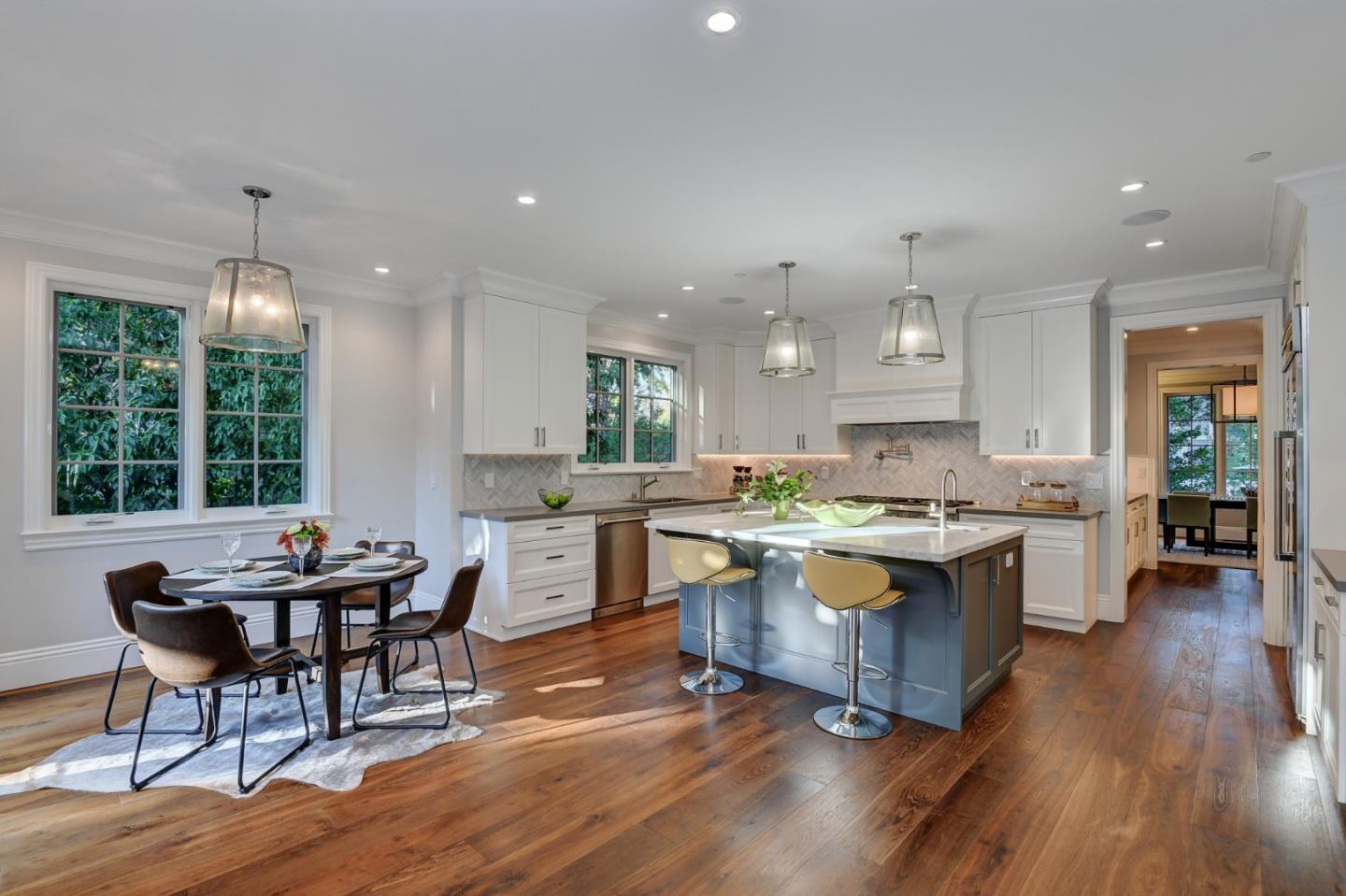 1025 Cabrillo Avenue Burlingame, CA 94010 - Photo 8 of 39 a kitchen with a sink cabinets and wooden floor