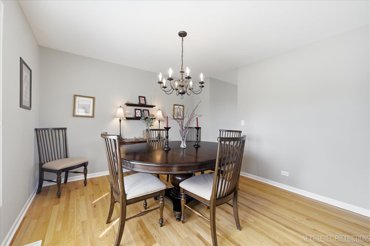 2984 Marshfield Court Elgin, IL 60124 - Photo 16 of 40 a dining room with furniture and chandelier