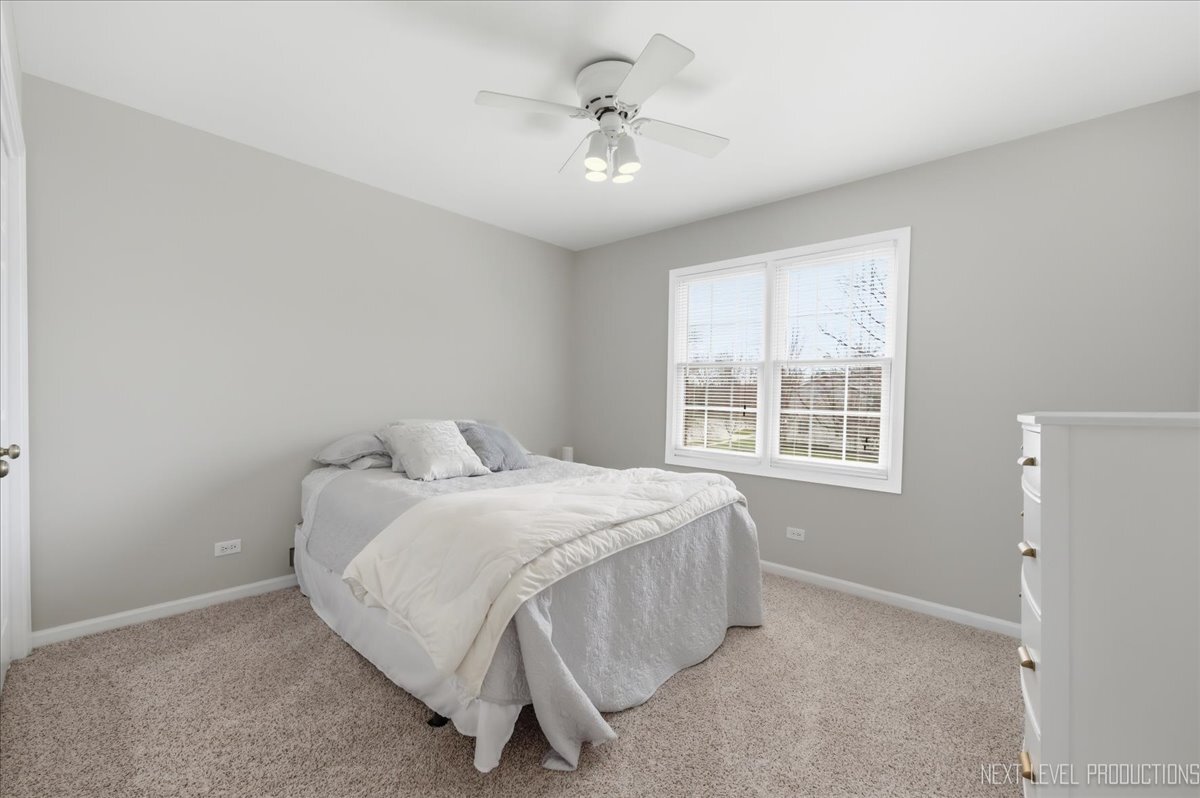 2984 Marshfield Court Elgin, IL 60124 - Photo 25 of 40 a bed sitting in a bedroom next to a window