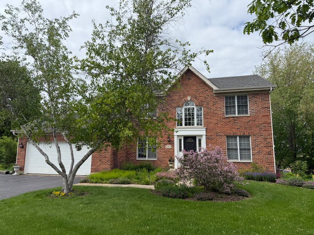 2984 Marshfield Court Elgin, IL 60124 - Photo 40 of 40 a front view of a house with a garden and yard