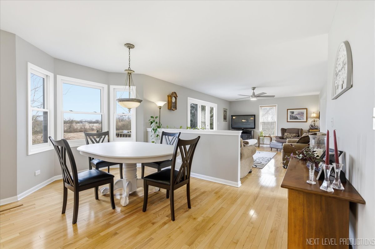 2984 Marshfield Court Elgin, IL 60124 - Photo 9 of 40 a view of a dining room with furniture and wooden floor