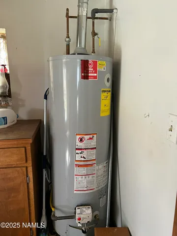 a backyard of a house with barbeque oven table and chairs