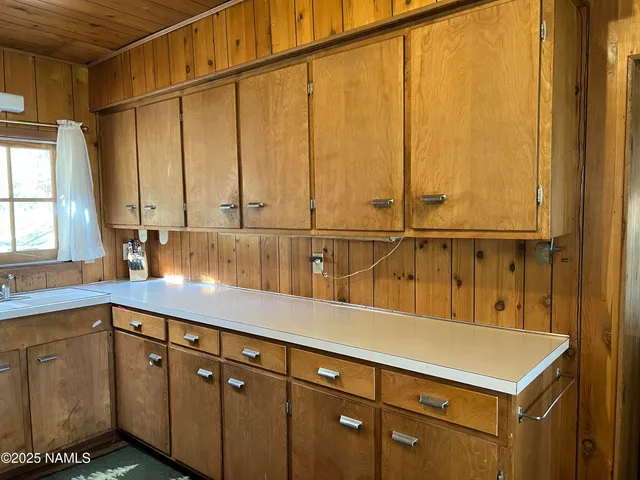 a kitchen with a sink and cabinets