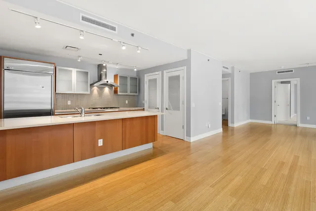 a kitchen with granite countertop a sink and cabinets