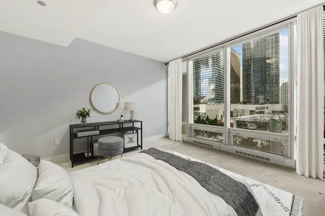 a bedroom with bed and wooden floor