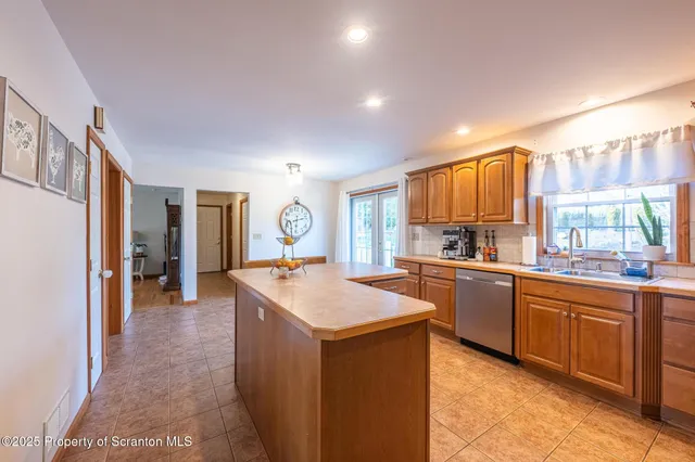 a kitchen with stainless steel appliances granite countertop a sink refrigerator and cabinets