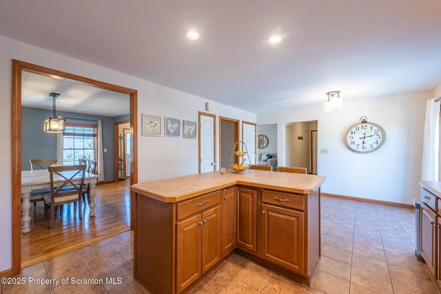 a open kitchen with cabinets table and chairs