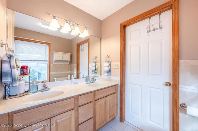 a bathroom with a toilet a sink and a window