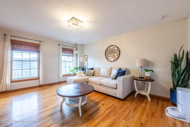 a dining table with chairs and window