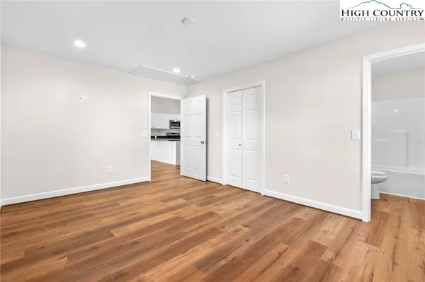a view of empty room with wooden floor