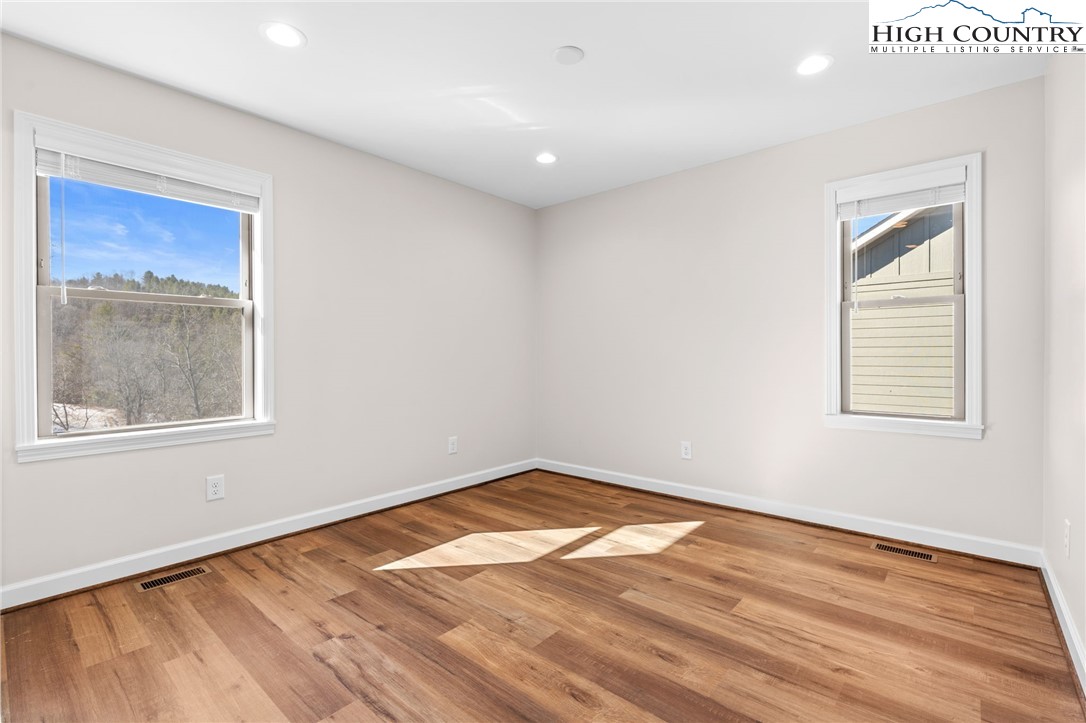 245 Ava Way, Unit 108 Boone, NC 28607 - Photo 19 of 29 an empty room with wooden floor and windows