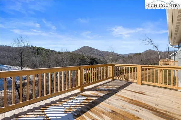 a view of balcony with wooden floor and fence