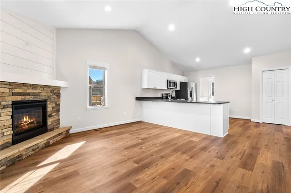 a view of kitchen with microwave and cabinets