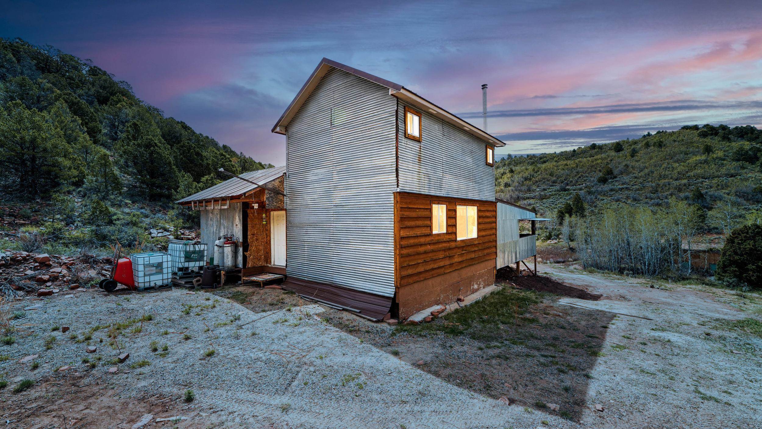 7465 Uncompahgre Divide Road Whitewater, CO 81527 - Photo 12 of 41 a view of a house with a yard