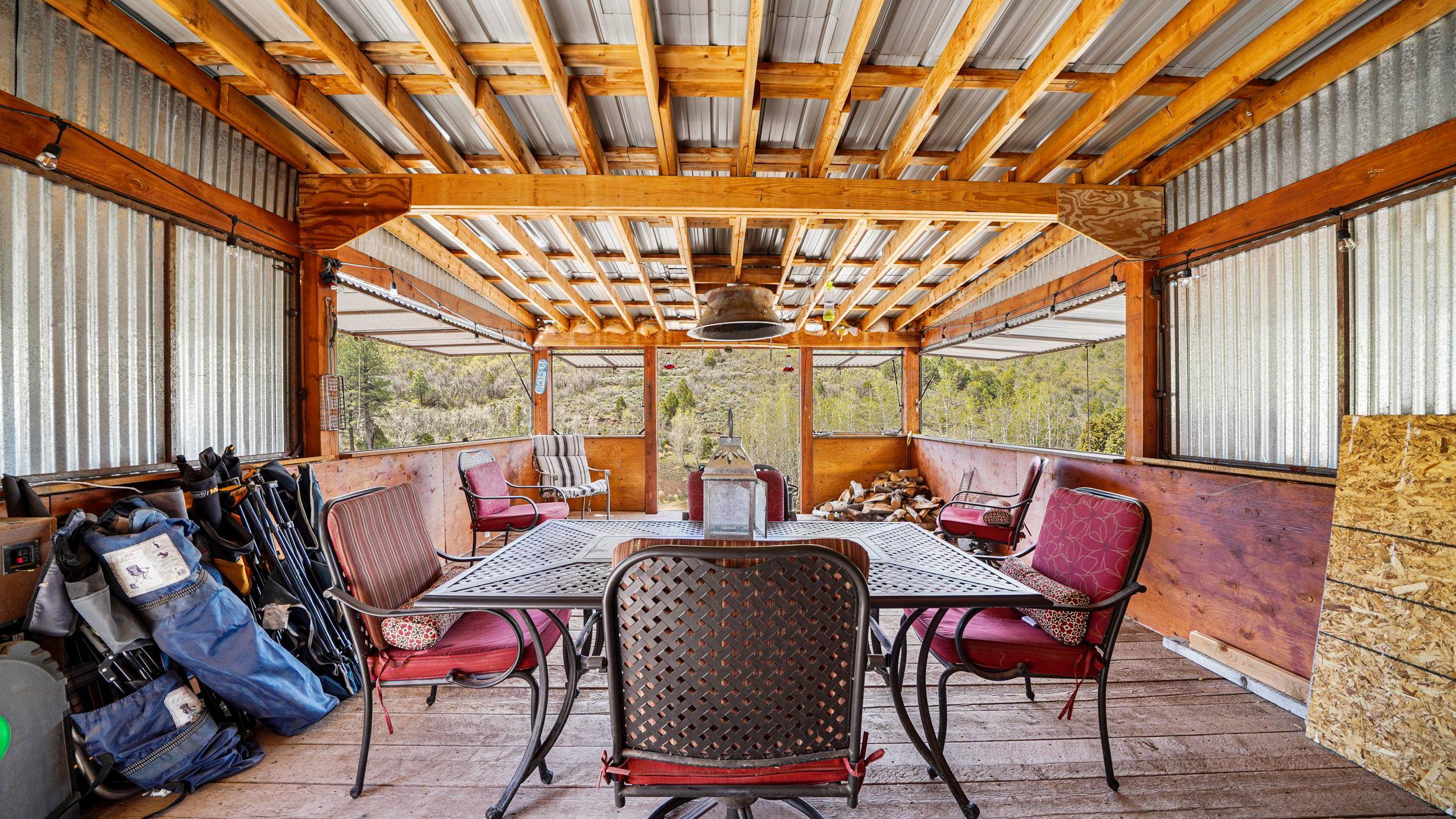 7465 Uncompahgre Divide Road Whitewater, CO 81527 - Photo 14 of 41 a dining room with furniture a chandelier and a rug