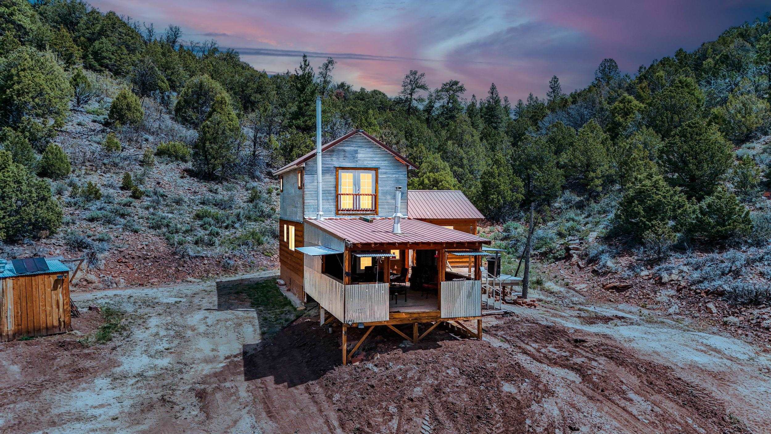 7465 Uncompahgre Divide Road Whitewater, CO 81527 - Photo 2 of 41 a table and chairs in front of the house