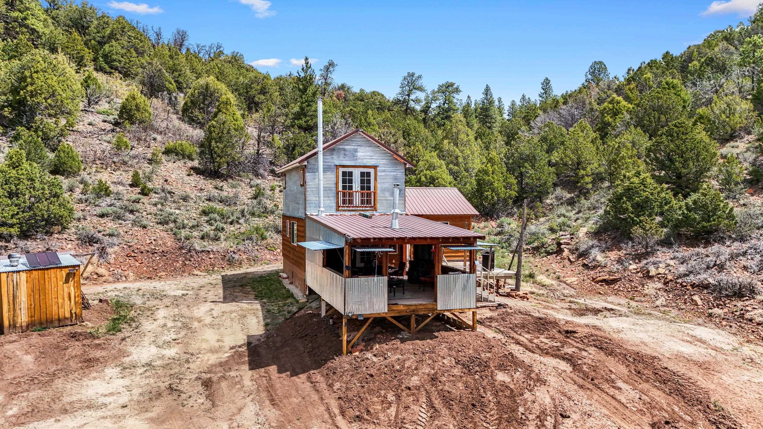 7465 Uncompahgre Divide Road Whitewater, CO 81527 - Photo 24 of 41 a view of a house with a patio