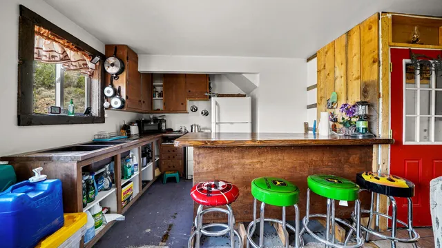 a kitchen with a stove a sink and a refrigerator