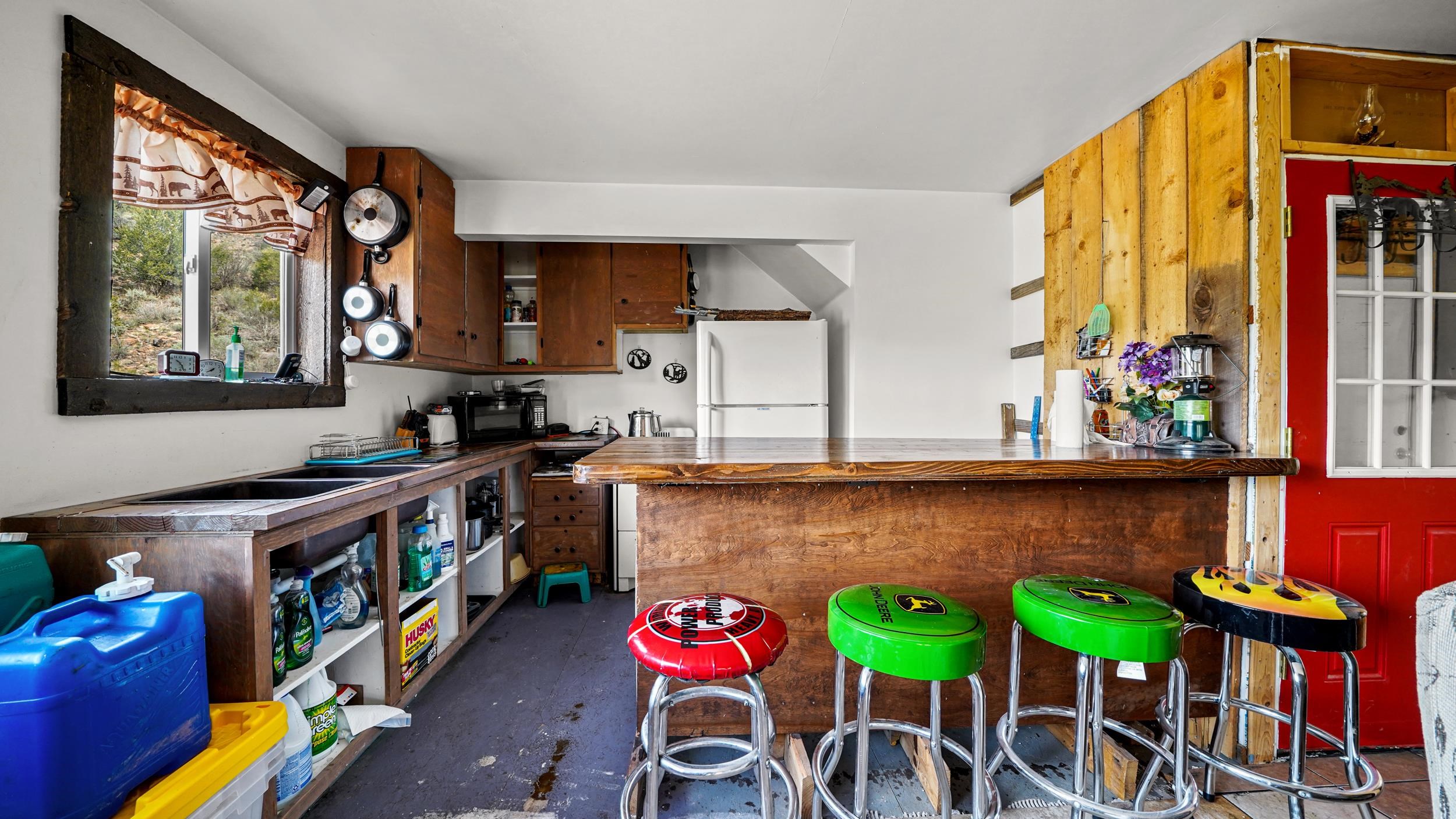 7465 Uncompahgre Divide Road Whitewater, CO 81527 - Photo 28 of 41 a utility room with lots of wooden furniture and a large window