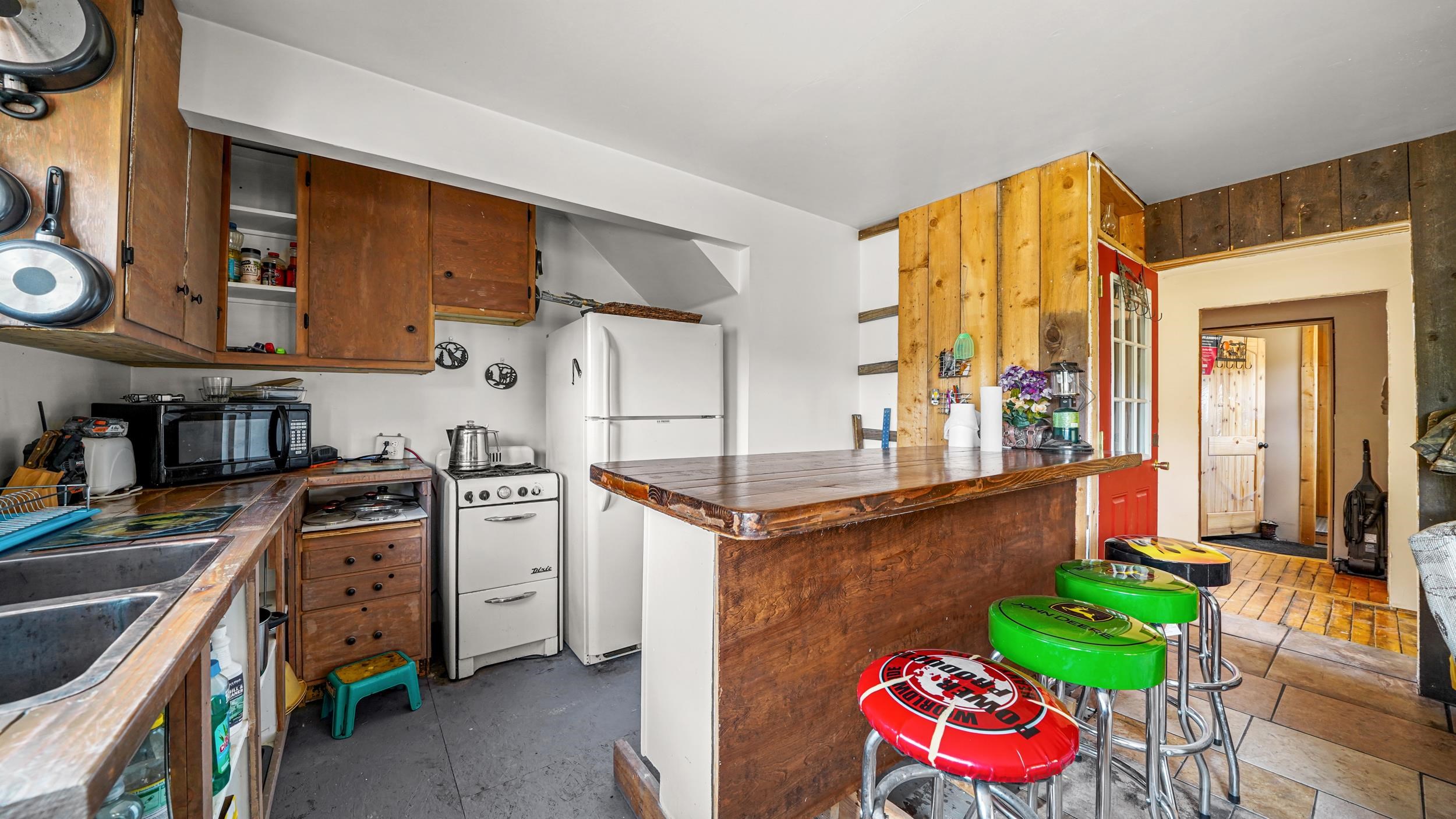 7465 Uncompahgre Divide Road Whitewater, CO 81527 - Photo 29 of 41 a kitchen with a stove a sink and a refrigerator