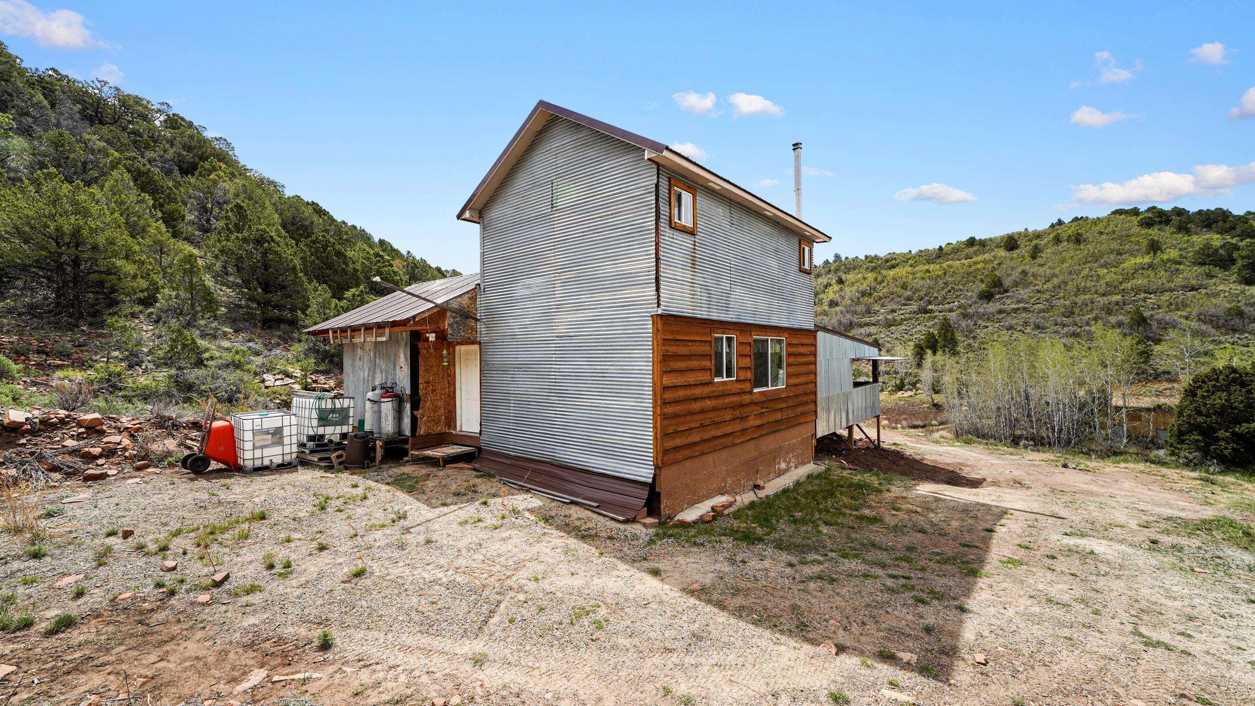 7465 Uncompahgre Divide Road Whitewater, CO 81527 - Photo 6 of 41 a view of a house with a yard