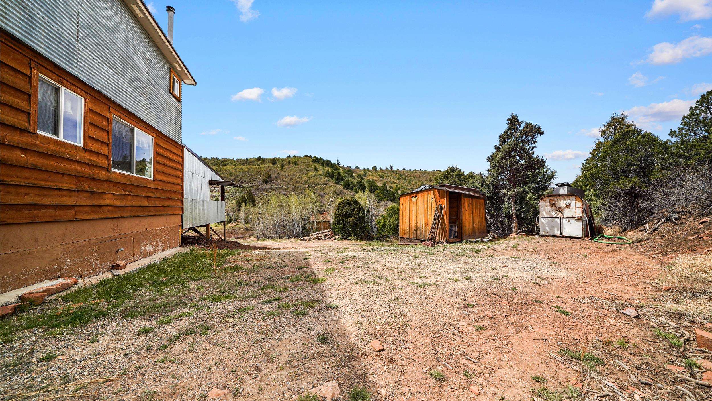 7465 Uncompahgre Divide Road Whitewater, CO 81527 - Photo 7 of 41 a large building with a large tree in front of it